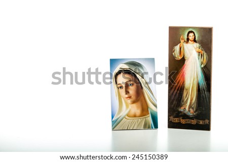 Icons  of Merciful Jesus and Our Lady of Medjugorje, the Blessed Virgin Mary isolated on white background with matte reflection on white table.