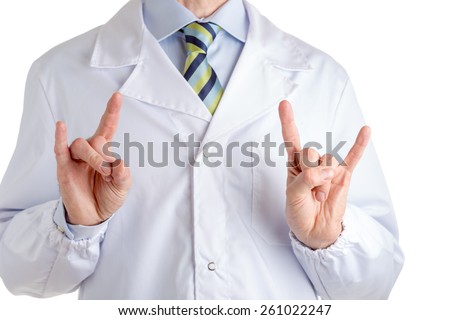 Man dressed with medical white coat, light blue shirt and regimental tie is making the sign of the horns, a gesture meaning luck, superstition, against evil eye