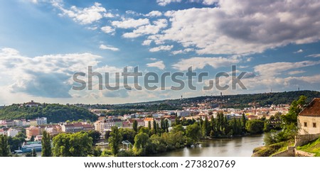 View of Prague from the Vltava river: house, trees, buildings and historical palaces