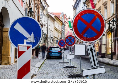 Misguiding road signs among Buildings  and houses in the historical center of Prague