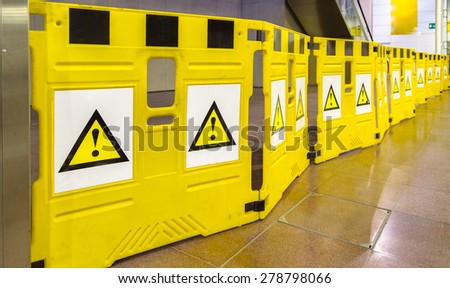 yellow mobile barriers with exclamation marks, please be careful and pay attention: there is a danger on your way