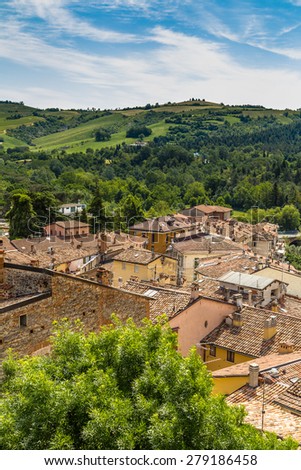 aerial view over red roofs and old houses facing each other in the old town of a country town in Italian countryside