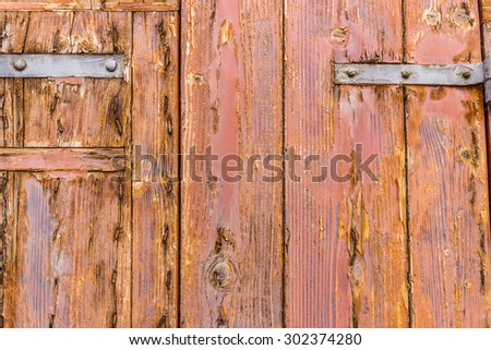old weathered door with rusty nails and peeling copal