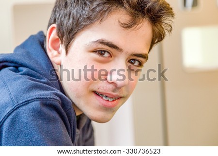 caucasian boy happy and smiling with braces on teeth