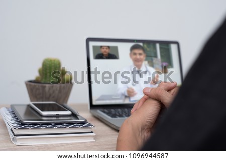 Patient consulting doctor via laptop computer at home or office, telemedicine, e health. Man having video chat with friendly doctor, medical online concept