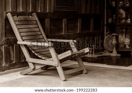 Antique wooden arm chair in old wooden house.