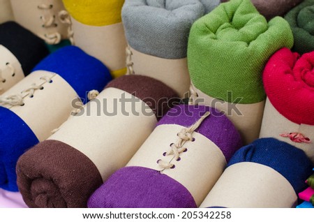 Rolls of colorful clothes, cute package with brown paper.