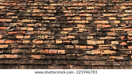 Old tile roof of the old wooden house, background.
