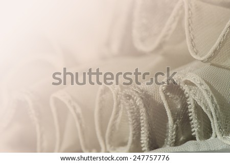 soft gray chiffon with curve and wave for the background, sepia.