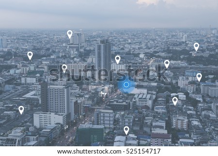 Searching location on map and pin above blue tone city scape and network connection, internet of things, satellite navigation system concept