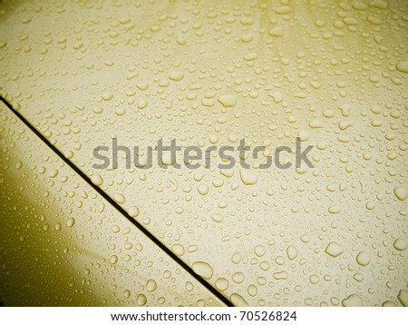 Gold car hood with water drops
