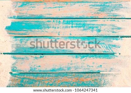 Beach background - top view of beach sand on old wood plank in blue sea paint background. summer vacation concept. vintage color tone.
