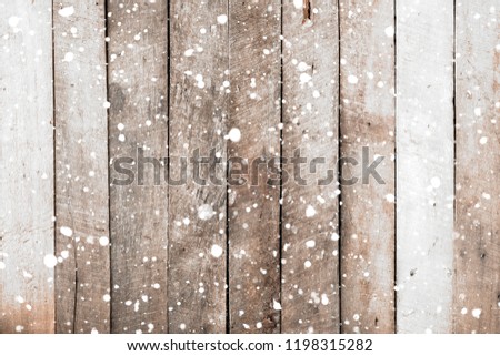 Vintage white wood wall with snow falling over. Christmas rustic background, winter scene.