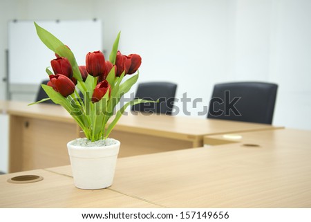 Business meeting room with Red flower and whiteboard in the background