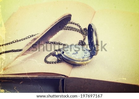 Vintage grunge  with antique pocket watch, and old book  ,quill