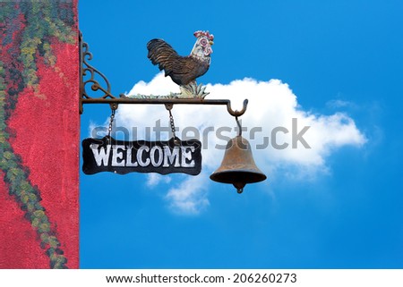 Classic Door Bell with silhouette  of  chicken, vintage welcome label  on blue sky with cloud