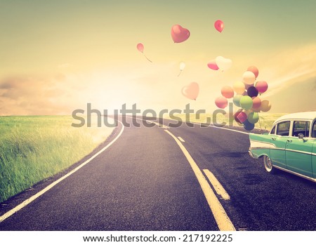Vintage Car with heart balloon concept of love in summer and wedding honeymoon