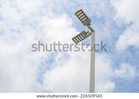 LED street lamps with energy-saving technology, cloud on sky background