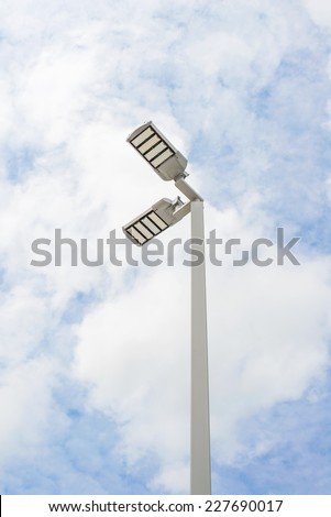 LED street lamps with energy-saving technology, cloud on sky background