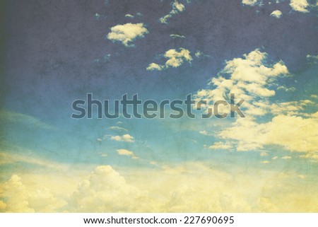 Sky in sunny day with white clouds vintage color toned on paper art texture