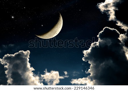 A fantasy of night sky cloudscape with stars and a crescent moon overlaid, vintage color toned