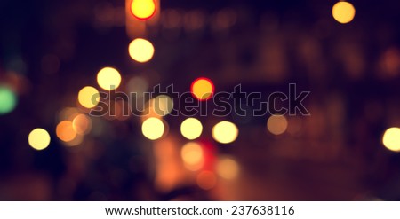 Artistic style - Defocused urban abstract texture ,bokeh of city lights in the background with blurring lights for your design, vintage or retro color tone