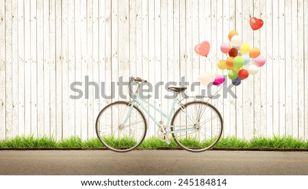 bicycle vintage with heart balloon concept of love in summer and wedding honeymoon, white wood background