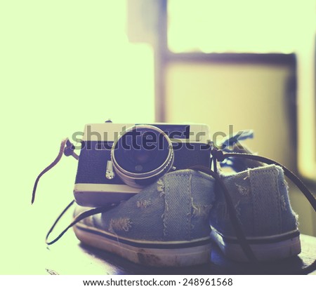 Vintage camera with Sneakers sun light background, instagram filter