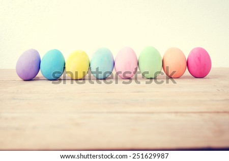 Vintage colorful easter eggs on wood table empty background