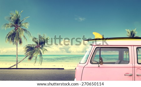 Vintage car in the beach with a surfboard on the roof