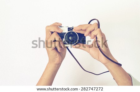 Man\'s hands holding vintage old camera with retro instagram filter effect