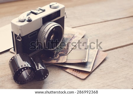 Vintage film camera on wood background with instagram retro filter effect