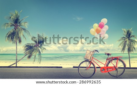 vintage bicycle with balloon on beach blue sky concept of love in summer and wedding honeymoon