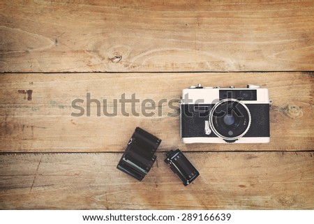 Vintage film camera on wood background with instagram retro filter effect