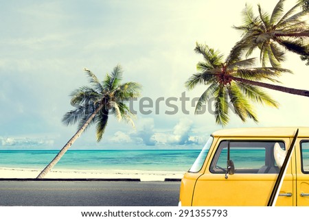 Vintage car on the beach with a surfboard
