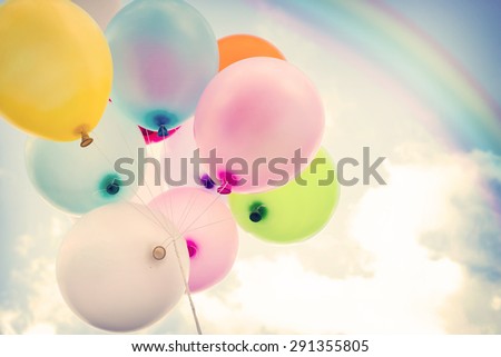 vintage colorful balloon with rainbow on blue sky concept of love in summer and valentine, wedding honeymoon