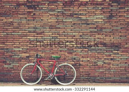 Retro bicycle on roadside with vintage brick wall background, Vintage instagram filter effect