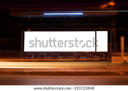 Blank billboard in night with long exposure light at bus stop