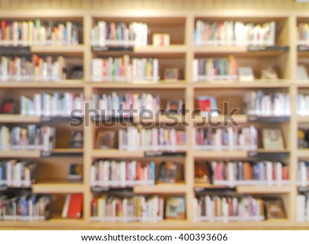 blurred bookshelf in library room for your background design