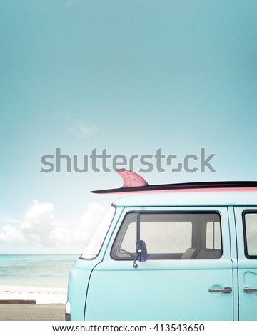 Vintage car parked on the tropical beach (seaside) with a surfboard on the roof