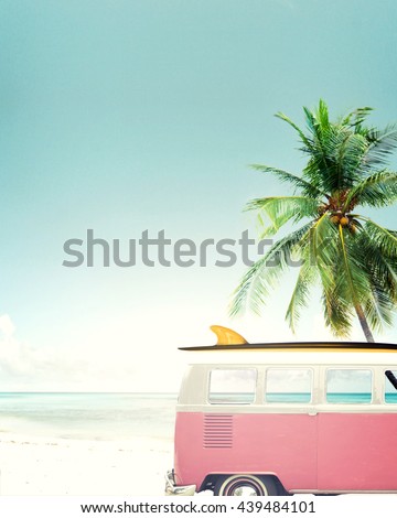Vintage car parked on the tropical beach (seaside) with a surfboard on the roof