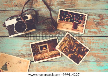 Merry christmas (xmas) photo album on old wood table. paper photo of film camera - vintage and retro style
