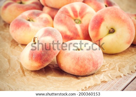 ripe juicy chinese flat peaches or Saturn peaches