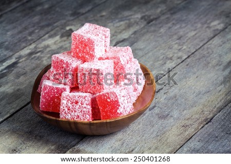 Turkish Delight in a wooden bowl on a rustic background