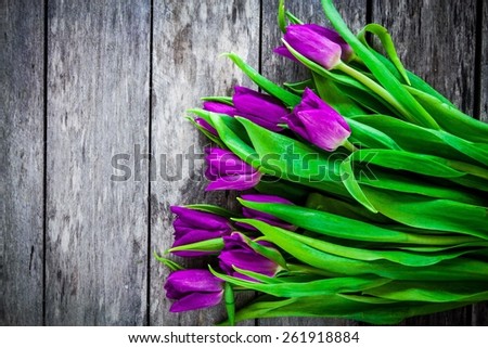 bouquet of purple tulips on a wooden background