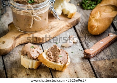 sandwiches with homemade chicken liver pate for breakfast on wooden cutting board