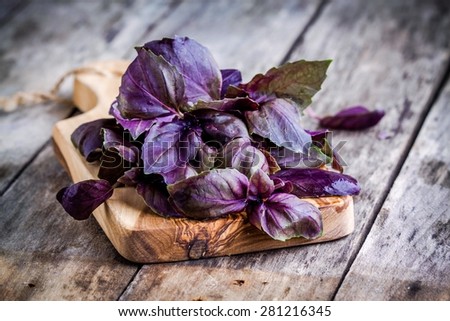 beam of purple basil on cutting board on the rustic wooden table