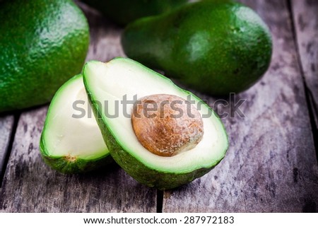 fresh raw avocado on a rustic wooden table