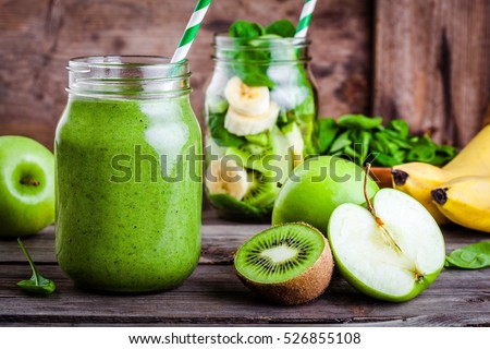 Green healthy  smoothie in  glass jar: banana, kiwi, spinach, green apple on rustic background