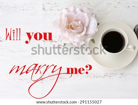 WILL YOU MARRY ME test, a cup of black coffee and a flower